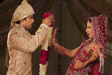 Indian bride rejecting a groom with a garland 