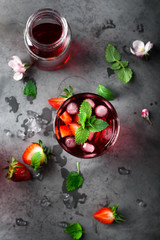 Fresh strawberry and mint drink on grey background.