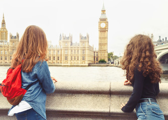 Two trendy teenage girls look at Big Ben, London