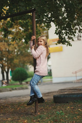 young happy girl swinging on the crossbar