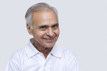 Portrait of man smiling over white background 