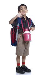 Smiling school boy waving his hand 