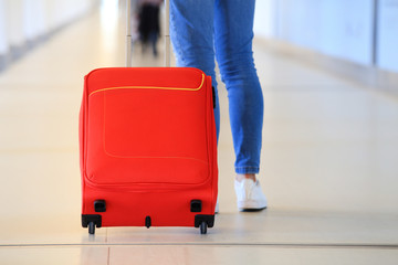 Red suitcase in airport close-up