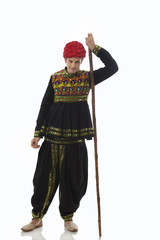 Portrait of a male dandiya dancer with a stick 