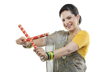 Gujarati woman with dandiya sticks 