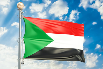 Sudanese flag waving in blue cloudy sky, 3D rendering