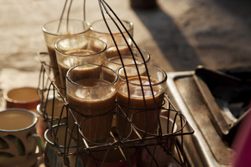 Fototapeta na wymiar Close-up of fresh traditional Indian chai kept in grid tray 