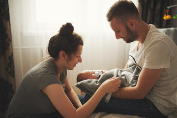 mother and father with newborn baby