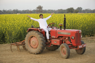 Fototapeta premium A farmer on his tractor 