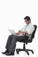 Handsome male executive busy working on laptop 