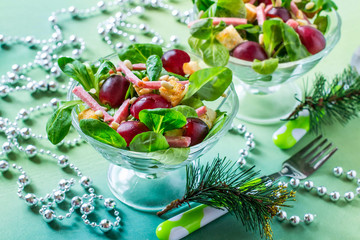 Festive salad with fresh corn salad, grapes, sausage and croutons