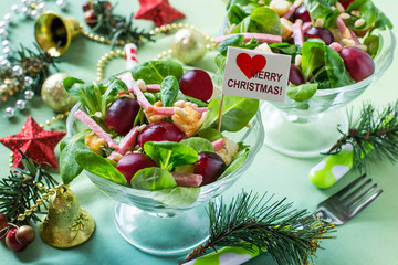 Festive salad with fresh corn salad, grapes, sausage and croutons