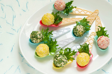 Small snack balls on serving spoons