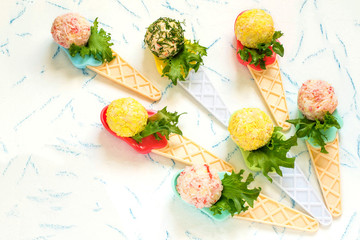 Small snack balls on serving spoons