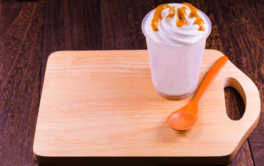 Chocolate ice cream in a cup on a grey wooden table wall background with copy space .