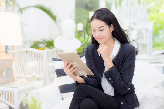 Young businesswoman asian sitting at table looking tablet, business concept.