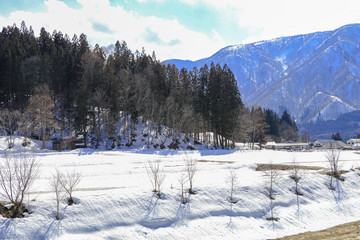 Hakuba mountain range   in the winter with snow on the mountain and blue sky and clouds background in Hakuba  Nagano Japan.