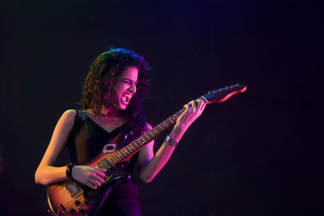 Fototapeta premium Young woman playing the guitar 