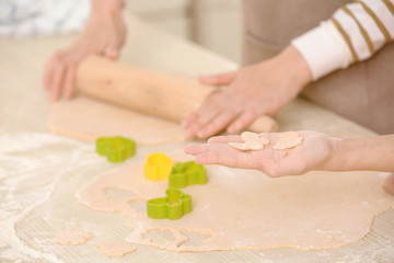 Mother and daughter cooking in light kitchen, closeup