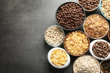 Different healthy breakfast cereals on gray background