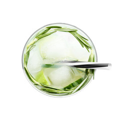 Glass with cold lemonade with cucumber and lime on white background