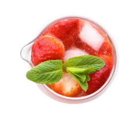 Glass jug of cold fruit cocktail on white background
