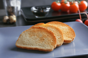 Plate with tasty breakfast toasts on table