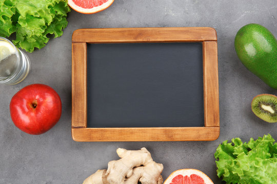 Diet concept. Chalkboard and different groceries on gray background