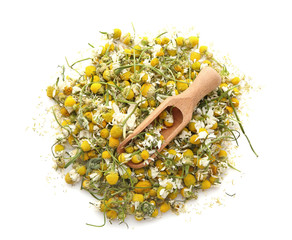 Dried chamomile flowers and wooden scoop on white background