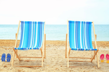 Pair of beach chairs at sea shore. Vacation concept