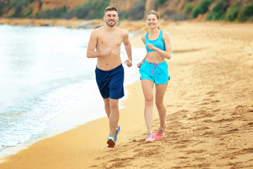 Young couple running on seashore