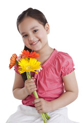 Portrait of little girl holding flowers