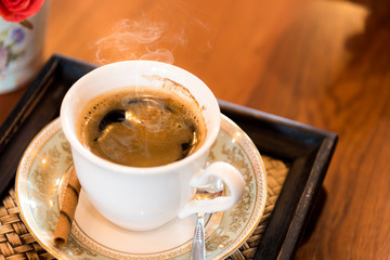 A cup of  coffee  on the wooden  table.