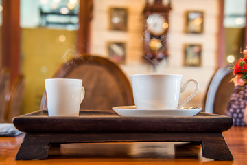 A cup of  coffee  on the wooden  table.