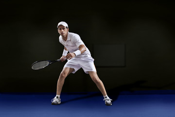 Fototapeta na wymiar Full length of man in sportswear playing tennis at court