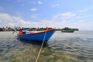 Naklejka na ściany i meble Small fishing boats anchored on the coast.