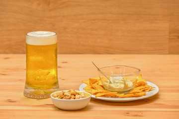 Beer and appetizers on wooden background