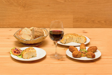 Wine with appetizers. Spanish omelette and croquettes