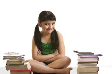 Girl sitting with a pile of books