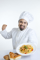 Portrait of chef with plate of pasta