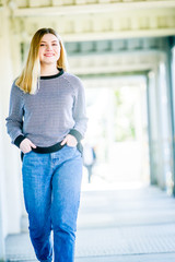 outdoor portrait of young happy smiling teen girl, natural outdoor background