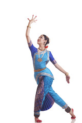 Full length of young woman performing Bharatanatyam over white background