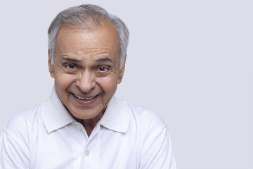 Obraz premium Senior man smiling over white background 