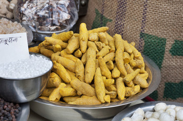 Close-up of Turmeric root and sabudana for sale at the shop