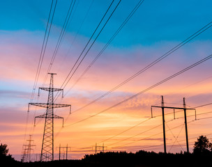 high-voltage power lines at sunset. electricity distribution station. high voltage electric transmission tower.