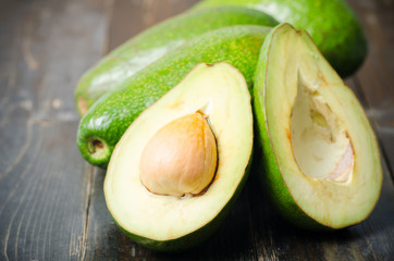 Half of avocado fruit on wooden background,Healthy fruit
