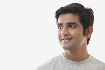 Smart young man smiling over white background 