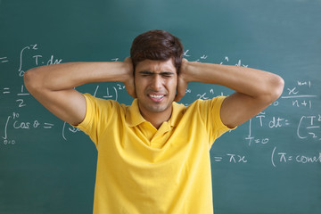 College student closing his ears