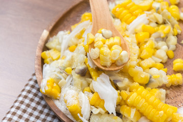 Sweet Corn with coconut and sugar on wooden plate