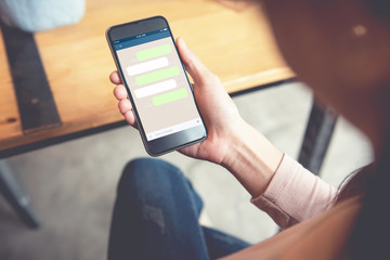 Closeup woman hand holding smart phone, Mock up Blank template chat box for text. Social network, Chating and messaging concept © oatawa